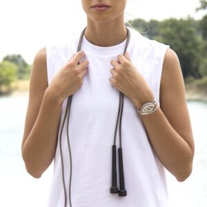 "Image of the Heala Beat Health Tracker Bracelet. The sleek, modern design features a comfortable, adjustable band in a neutral color. The central module, equipped with a digital display, monitors health metrics such as heart rate, steps taken, and sleep patterns. The bracelet is lightweight and water-resistant, making it suitable for daily wear and various activities."