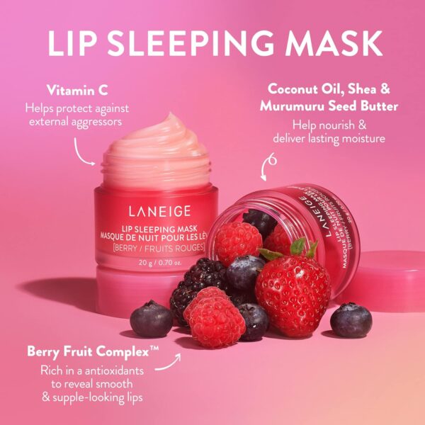 Alt text: A pink jar of LANEIGE Lip Sleeping Mask sits on a white surface, surrounded by fresh berries. The jar is open, revealing the creamy texture of the mask. The product promises to rejuvenate lips overnight, providing deep hydration and leaving them soft and supple.