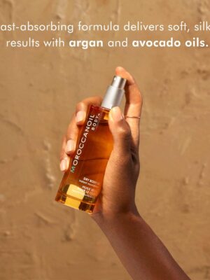 A sleek bottle of Moroccanoil Dry Body Oil with a minimalist design. This luxurious body oil spray is enriched with argan oil and quickly absorbs into the skin, leaving it smooth, hydrated, and radiant. Ideal for daily use to nourish and enhance skin's natural glow."