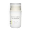 A white jar of "Beekman 1802 Bloom Cream Daily Face Moisturizer" with a minimalist label, set against a soft, pastel background.
