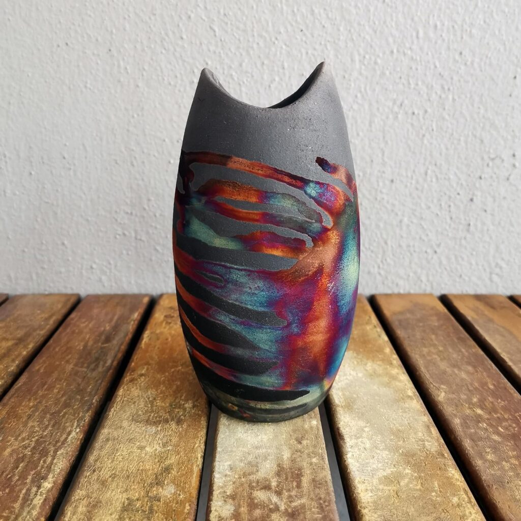 *"Koi 6.3-inch Handmade Ceramic Raku Vase"* is a stunning piece of pottery. Crafted with care, this vase features intricate details and a **boho** aesthetic. Whether you're gifting it to someone special or adding it to your own collection, this vase promises elegance and artistic flair. 🎨🌸🎁