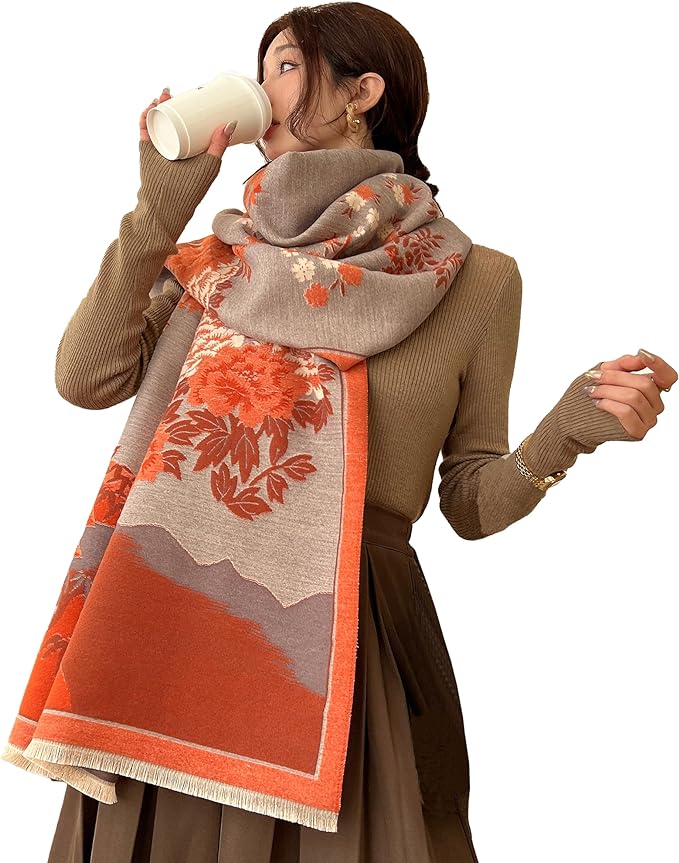 A large, soft pashmina shawl in an orange color, with a cashmere feel. It can be used as a warm scarf in cold weather or as a throw blanket for napping.”