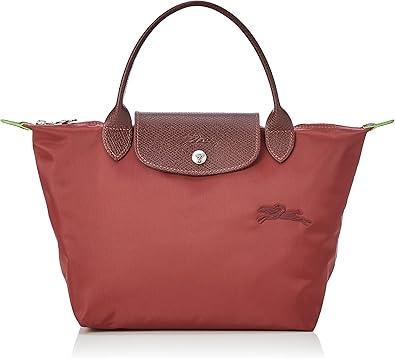 “Effortlessly chic, the Longchamp Le Pliage Medium Handbag combines timeless design with practicality. Crafted from durable materials, this foldable tote features a spacious interior, sturdy handles, and the signature Le Pliage foldable flap. Perfect for everyday elegance and travel adventures