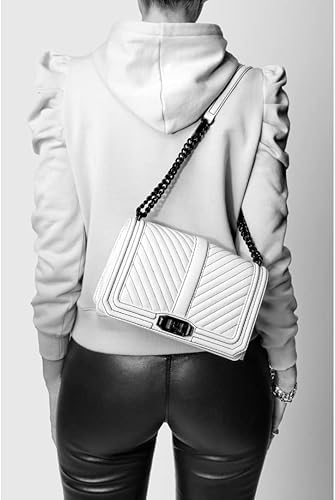 “Chic and versatile, the Rebecca Minkoff Chevron Quilted Love Crossbody Bag features a distinctive chevron pattern. Crafted from high-quality materials, this crossbody bag boasts a compact silhouette, a chain strap, and the iconic Love lock closure. Perfect for day-to-night transitions!”