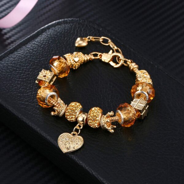 **Alt Text:** A close-up of the Leprato Gold Plated Heart Crown Charm Pendant Glass Crystal Beaded Bracelet, showcasing its gold-plated heart crown charm and colorful glass crystal beads, designed as an elegant jewelry gift for women.