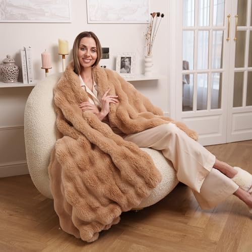 An ultra-soft, light brown faux fur throw blanket measuring 60" x 80". This big, fluffy luxury boho blanket is perfect for adding a cozy, aesthetic touch to any bed, couch, or living room. Ideal for creating a warm, inviting atmosphere and ensuring ultimate comfort.