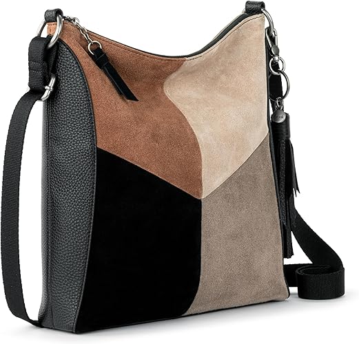 A premium leather women's crossbody purse by The Sak, featuring a stylish colorblock design. This handbag is perfect for everyday use and travel, offering practicality with its convenient zipper closure and adjustable strap. Ideal for adding a touch of elegance to any outfit.