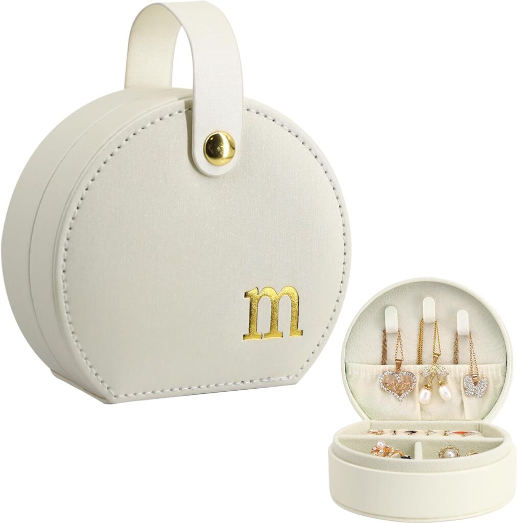 COLLECTIVE HOME Travel Jewelry Case. Elegant half-moon design with a gold monogram, perfect for stylish and secure storage of your jewelry while traveling