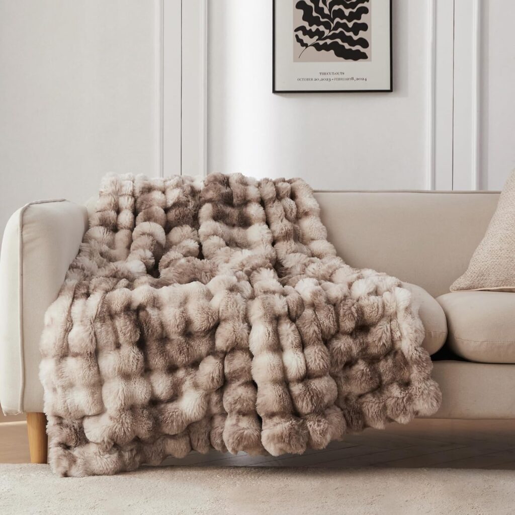 COOVA Faux Rabbit Fur Flannel Throw Blanket, measuring 50x60 inches. This luxury blanket is fuzzy, cozy, and soft, designed for all-season comfort. It adds a touch of elegance and warmth to any space."